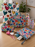 The Heart Collection gift set featuring heart print tote bag, cosmetic bag, wet bag, laptop bag, pom pom pens, water bottle and flask